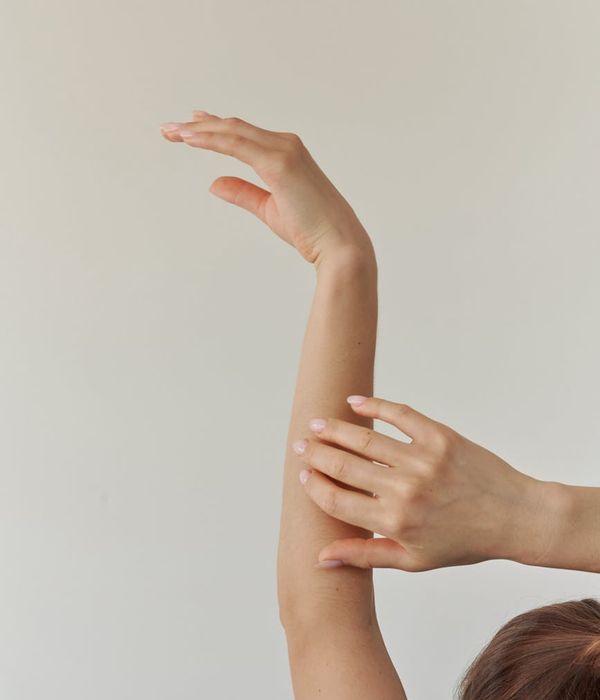 Woman in a graceful yoga pose with cornflower blue light accents.